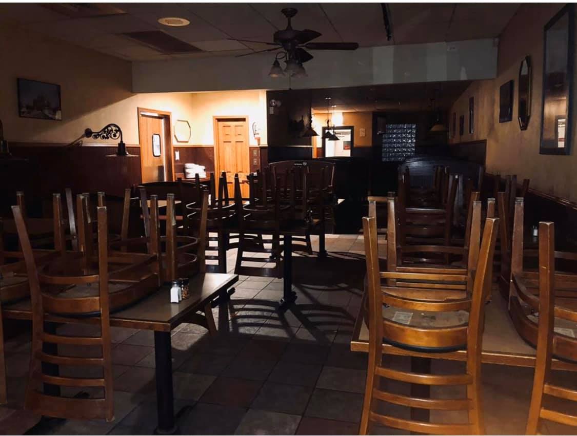 The cozy, wood-paneled interior dining room of Rosangela's Pizza